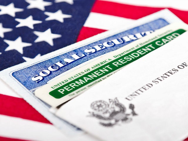 Social Security card and permanent resident on USA flag - stock photo United States of America social security and green card with US flag on the background.