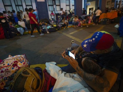 Venezuelan citizens wait in line to get a refugee application at a Peruvian border post at the binational border attention centre (CEBAF) in Tumbes on June 13, 2019. - "Between 11 and 12 June, more than 6,000 Venezuelans have entered the national territory," said Wilmer Dios, governor of the northern …