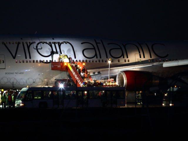 LONDON, ENGLAND - DECEMBER 29: Passengers are helped to disembark the Virgin Atlantic Boei