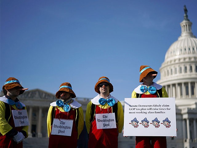 WASHINGTON, DC - NOVEMBER 15: Counter protesters dress as Pinocchio while standing on the periphery of a rally against the proposed Republican tax reform legislation on the east side of the U.S. Capitol November 15, 2017 in Washington, DC. The rally was organized by a large group of liberal organizations, …