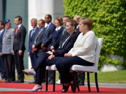 Merkel sits during anthems after shaking spells