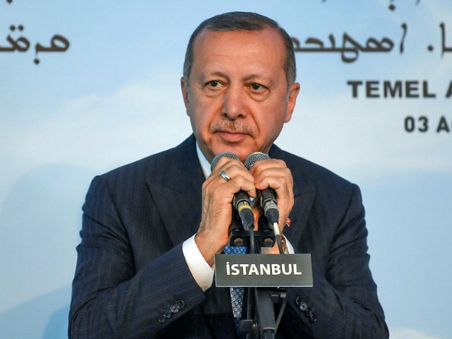 Turkish President Recep Tayyip Erdogan holds the microphones as he delivers a speech during the first stone ceremony of Turkey's first church in the modern history of the modern Republic in Istanbul's Yesilkoy district, on August 3, 2019. - President Recep Tayyip Erdogan on August 3 laid a stone for Turkey's first new church in the history of the modern Republic during a groundbreaking ceremony in Istanbul. (Photo by Ozan KOSE / AFP) (Photo credit should read OZAN KOSE/AFP/Getty Images)
