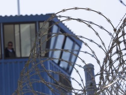 FILE - In this Aug. 17, 2011, file photo, concertina wire and a guard tower are seen at Pe