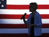 Democratic presidential candidate Elizabeth Warren, D-Mass., is silhouetted as she speaks during a rally Monday, Aug. 19, 2019, at Macalaster College during a campaign appearance in St. Paul, Minn. (AP Photo/Jim Mone)