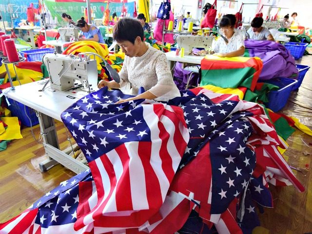 Chinese employees sew U.S. flags at a factory in Fuyang in China's eastern Anhui province on July 13, 2018. #