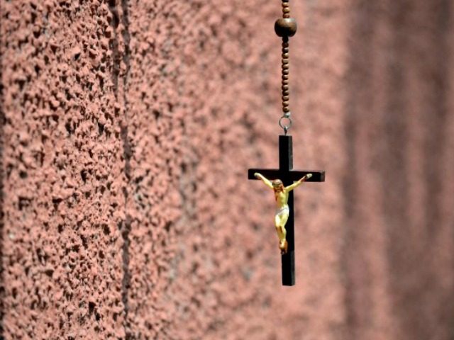 A wooden rosary with an image of the crucifixion of Jesus Christ is displayed at a roadside shop in New Delhi on April 3, 2015, on Good Friday. Christians account for 2.3 percent of India's billion-plus Hindu majority population.AFP PHOTO/ PRAKASH SINGH (Photo credit should read PRAKASH SINGH/AFP/Getty Images)