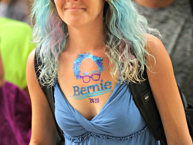 DES MOINES, IOWA - AUGUST 11: A supporter with an image of Democratic presidential candidate Sen. Bernie Sanders (I-VT) painted on her chest arrives at the Iowa State Fair August 11, 2019 in Des Moines, Iowa. Twenty-two of the 23 politicians seeking the Democratic Party presidential nomination will be visiting …