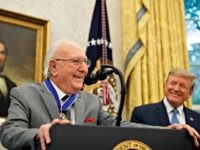 Former NBA basketball player and coach Bob Cousy, of the Boston Celtics, speaks as President Donald Trump smiles during a Presidential Medal of Freedom ceremony for Cousy, in the Oval Office of the White House, Thursday, Aug. 22, 2019, in Washington. (AP Photo/Alex Brandon)