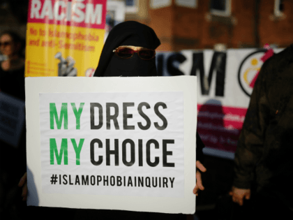 UXBRIDGE, ENGLAND - AUGUST 09: Local people protest outside the Hillingdon Conservative Association office on August 9, 2018 in Uxbridge, England. Today's protest is being held following comments made by former Foreign Secretary, Boris Johnson, against the wearing of Burkas by Muslim women in the United Kingdom. An independent panel …