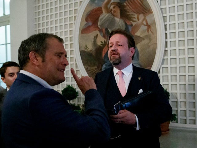 Radio host Sebastian Gorka, right, speaks with Playboy's Brian Karem, left, after Presiden
