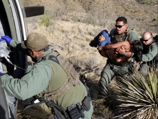 U.S. Border Patrol agents rescue a Guatemalan woman found unresponsive in the Arizona desert Mountains with the assistance of a CBP AMO helicopter aircrew. (Photo: U.S. Border Patrol/Tucson Sector)