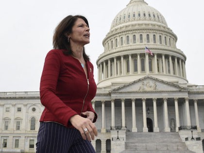 FILE - In this Jan. 4, 2019 file photo, Rep. Cheri Bustos, D-Ill., walks to a group photo with the women of the 116th Congress on Capitol Hill in Washington. A mass departure of top aides is shaking House Democrats’ campaign arm after Hispanic and black members of Congress complained …