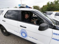 In this Monday, July 18, 2016, photograph, Denver Police Department officers head out to their patrol car after role call for the swing shift in District 6 in downtown Denver. After more than two decades of making officers patrol on their own, the city of Denver has revived two-officer patrols …