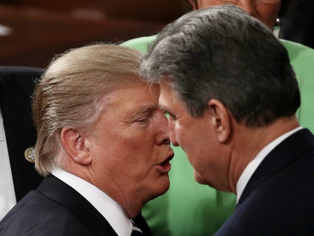 U.S. President Donald Trump (L) speaks with Sen. Joe Manchin (D-WV) after addressing a joint session of the U.S. Congress on February 28, 2017 in the House chamber of the U.S. Capitol in Washington, DC. Trump's first address to Congress focused on national security, tax and regulatory reform, the economy, …