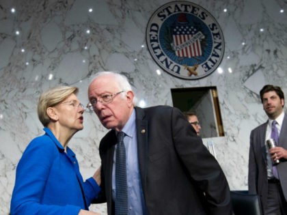 Sen. Elizabeth Warren, D-Mass. speaks with Sen. Bernie Sanders, I-Vt. at the Senate Health, Education, Labor, and Pensions Committee hearing with governors to discuses ways to stabilize health insurance markets​, on Capitol Hill in Washington, Thursday, Sept. 7, 2017. ( AP Photo/Jose Luis Magana)