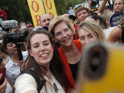 Democratic presidential candidate Sen. Elizabeth Warren, D-Mass., poses for a selfie at the Iowa State Fair, Saturday, Aug. 10, 2019, in Des Moines, Iowa. (AP Photo/John Locher)