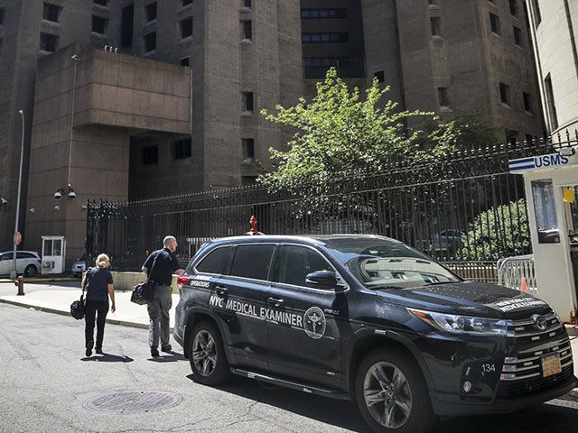New York City medical examiner personnel leave their vehicle and walk to the Manhattan Cor
