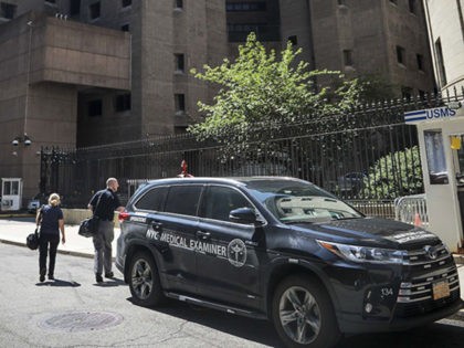 New York City medical examiner personnel leave their vehicle and walk to the Manhattan Cor