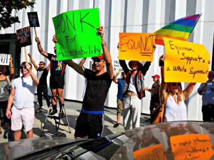 Protesters chant slogans and hold signs outside the luxury gym Equinox in West Hollywood, California, August 9, 2019, during a protest against the gym and fitness company SoulCycle as well as against President Trump and his benefactor Stephen Ross. - Stephen Ross, the billionaire owner of Equinox and SoulCycle, hosted …