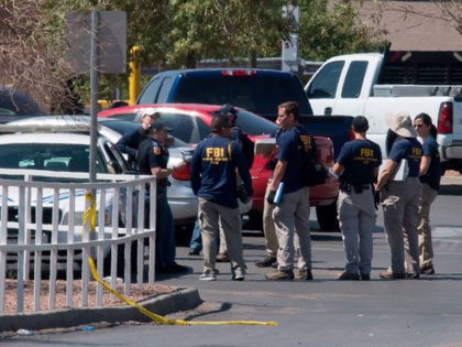 FBI agents check vehicles outside the Cielo Vista Mall Wal-Mart (background) where a shooting left 20 people dead in El Paso, Texas, on August 4, 2019. - Texas authorities are investigating the Saturday mass shooting at a Walmart store in El Paso as a possible hate crime, the city's police …