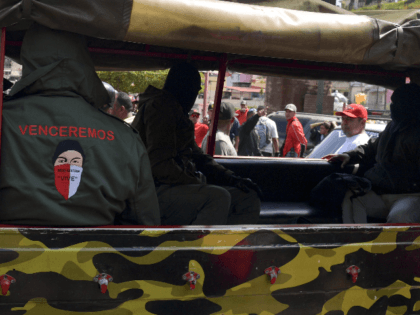 Masked members of a "colectivo" -pro-government cells- attend a rally in Caracas on Januar