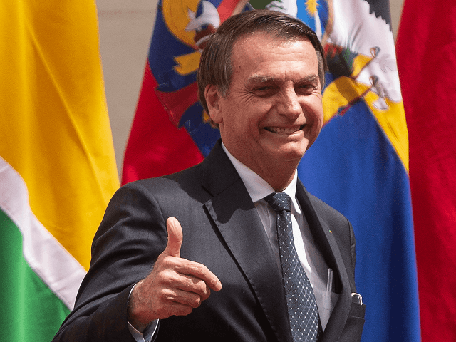 Brazil's President Jair Bolsonaro gives his thumb up during the signing of a declaration to kick off the Prosur regional initiative at La Moneda presidential palace in Santiago, on March 22, 2019. - The presidents of Chile, Colombia, Argentina, Brazil, Ecuador, Peru and Paraguay launched a new regional block that …