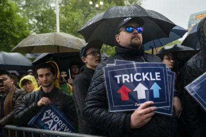 NEW YORK, NY - MAY 14: Supporters listen in the rain as Democratic presidential candidate Andrew Yang speaks during a rally in Washington Square Park, May 14, 2019 in New York City. One of Yang's major campaign promises is a universal basic income of $1,000 every month for every American …