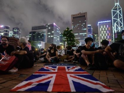 A British Union Jack flag is displayed as protesters gather along a fenced-off Victoria Ha