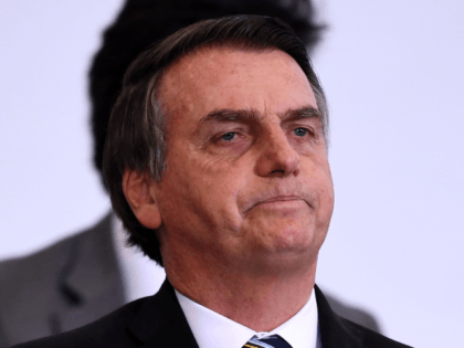 Brazilian President Jair Bolsonaro gestures during a ceremony to commemorate the first 200