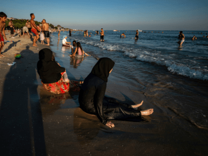 Syrian women sit on the beach at Menekse on July 28, 2019, in Istanbul. - Syrians living illegally in Istanbul have until August 20 to leave the city or face expulsion, authorities warned on July 22, as hostility mounts towards the millions of refugees in Turkey. Turkey has 3.5 million …