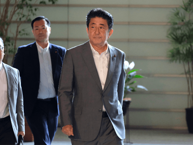 Japan's Prime Minister Shinzo Abe (R) arrives at the prime minister's office in Tokyo on July 31, 2019, after reports North Korea fired two ballistic missiles earlier in the morning. - Pyongyang fired two ballistic missiles on July 31, Seoul said, days after a similar launch that the nuclear-armed North …