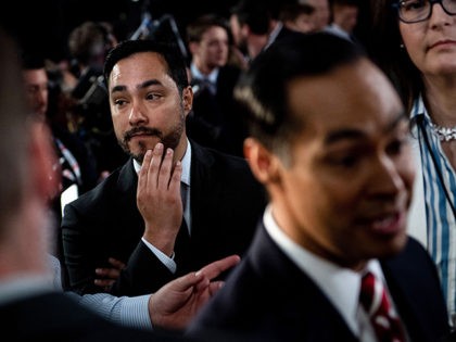 Joaquin Castro (L) listens to his brother Democratic presidential hopeful Former US Secretary of Housing and Urban Development Julian Castro (R) speak to reporters in the spin room after the second round of the second Democratic primary debate of the 2020 presidential campaign season hosted by CNN at the Fox …