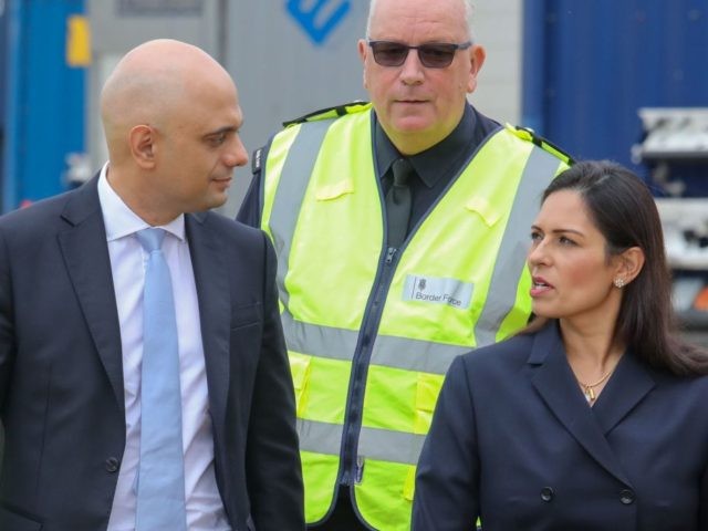 Britain's Chancellor of the Exchequer Sajid Javid (L) and Britain's Home Secretary Priti Patel (R) visit Tilbury Docks in Tilbury, east of London, on August 1, 2019. - Finance minister Sajid Javid announced Wednesday an extra £2.1 billion ($2.6 billion, 2.3 billion euros) to prepare for leaving without an agreement, …