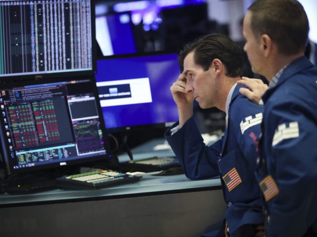 NEW YORK, NY - AUGUST 1: Traders and financial professionals work ahead of the closing bel