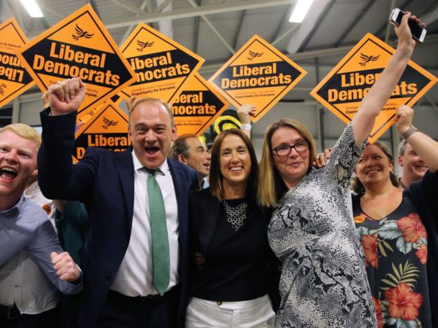 Liberal Democrat candidate Jane Dodds (C) celebrates with Liberal Democrat MP Ed Davey (L)