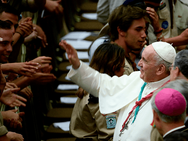 Pope Francis waves to faithful and wears a scout scarf given by a participant, during the Euromoot meeting (Federation of European Scouting) in the Paul VI hall at the Vatican, on August 3, 2019. (Photo by Filippo MONTEFORTE / AFP) (Photo credit should read FILIPPO MONTEFORTE/AFP/Getty Images)