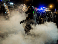 Police fire tear gas during a protest in the district of Causeway Bay in Hong Kong on August 4, 2019. - Riot police fired tear gas on August 4 at protesters on Hong Kong's main island, the second consecutive night of unrest in a territory battered by weeks of anti-government …