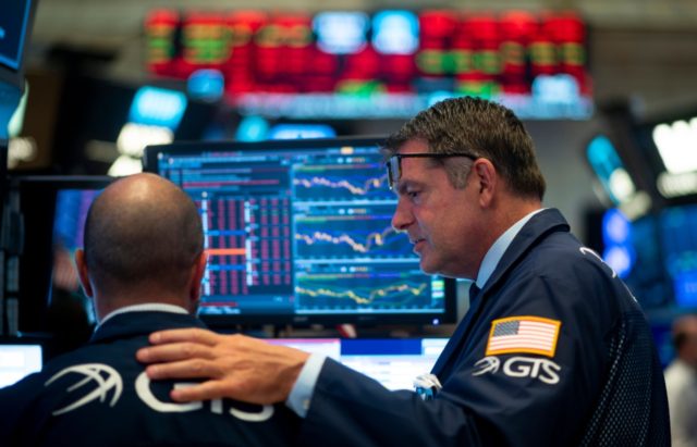 Traders react after the closing bell at the New York Stock Exchange (NYSE) on August 5, 20