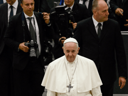 Pope Francis (C) leaves after his weekly general audience, in the Pope Paul VI hall at the