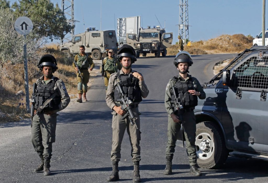 Israeli soldiers stand guard next to the site where the body of an Israeli soldier was found with multiple stabs near the settlement of Migdal Oz in the occupied West Bank on August 8, 2019. - An Israeli soldier's body was found with multiple stab wounds near a Jewish settlement in the occupied West Bank in what Prime Minister Benjamin Netanyahu called a "terrorist" attack. The incident sparked a manhunt by security forces and risked boosting Israeli-Palestinian tensions weeks ahead of September 17 Israeli polls. (Photo by Menahem KAHANA / AFP) (Photo credit should read MENAHEM KAHANA/AFP/Getty Images)