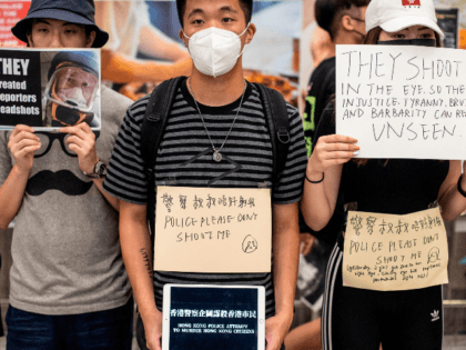 Protesters hold placards at Hong Kong's international airport following a protest against the police brutality and the controversial extradition bill on August 12, 2019. - Global stock markets dropped on August 12 as escalating protests in Hong Kong forced the closure of the financial hub's airport, adding geopolitical worries to …