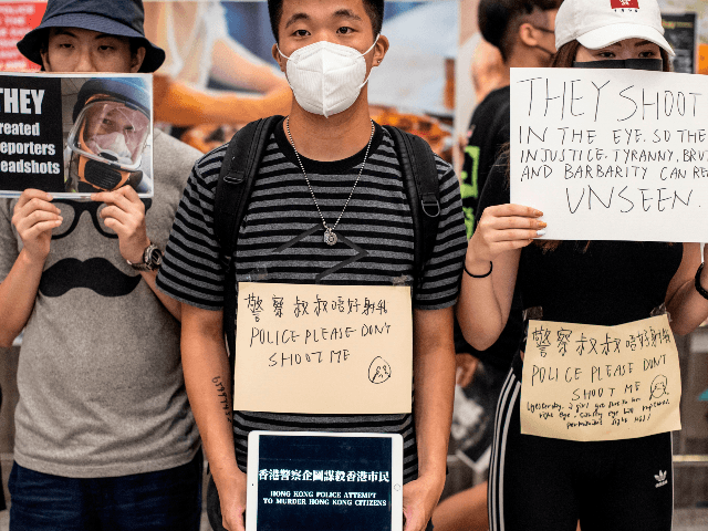 Protesters hold placards at Hong Kong's international airport following a protest against