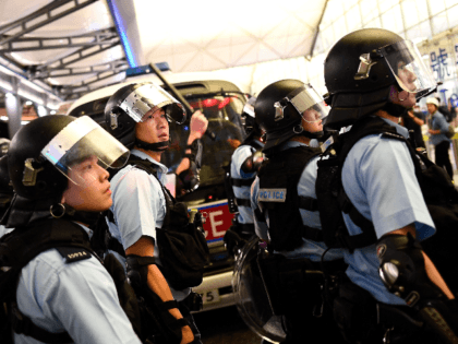 Police secure Terminal 1 after a scuffle with pre-democracy protestors at Hong Kong's International Airport on August 13, 2019. - Hundreds of flights were cancelled or suspended at Hong Kong's airport on August 13 as pro-democracy protesters staged a second disruptive sit-in at the sprawling complex, defying warnings from the …