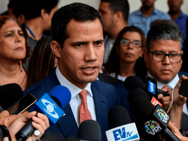 Venezuelan opposition leader and self-proclaimed acting president Juan Guaido speaks with