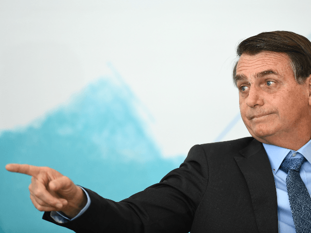 Brazilian President Jair Bolsonaro gestures during the International Youth Day celebration at Planalto Palace in Brasilia on August 16, 2019. - Bolsonaro criticized a possible victory of Presidential candidate for the Frente de Todos (Front for All) party Alberto Fernandez in the upcoming elections in Argentina. (Photo by EVARISTO SA …