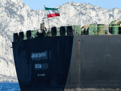An Iranian flag flutters on board the Adrian Darya oil tanker, formerly known as Grace 1, off the coast of Gibraltar on August 18, 2019. - Gibraltar rejected a US demand to seize the Iranian oil tanker at the centre of a diplomatic dispute as it prepared to leave the …