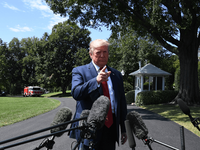 US President Donald Trump speaks to the media as he departs the White House in Washington,