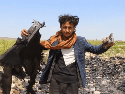This AFPTV screen grab from a video made on August 21, 2019, shows people searching reportedly the wreckage of a US drone following an alledged attack by pro-Iranian Huthi forces in Yemen's southwestern Dhamar province. - The US military said on August 21 that it is investigating reports that one …