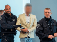 Syrian defendant Alaa Sheikhi (C) is escorted into the courtroom for a hearing in his trial over a knife killing that sparked far-right street violence and protests in the eastern German city of Chemnitz on August 22, 2019 in Dresden, eastern Germany. - In the high-profile manslaughter case, in which …