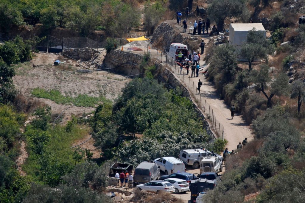 An Israeli ambulance and security forces gather in the Palestinian village of Dayr Ibzi close to the site where a bomb exploded near the Israeli settlement of Dolev in the occupied West Bank on August 23, 2019 injuring at least three people. - Israeli medics said an explosion near a water spring had injured three people, including a 17-year-old in critical condition. Two others, 46 and 20, were being evacuated to hospital by helicopter, the Magen David Adom rescue service said. (Photo by ABBAS MOMANI / AFP) (Photo credit should read ABBAS MOMANI/AFP/Getty Images)
